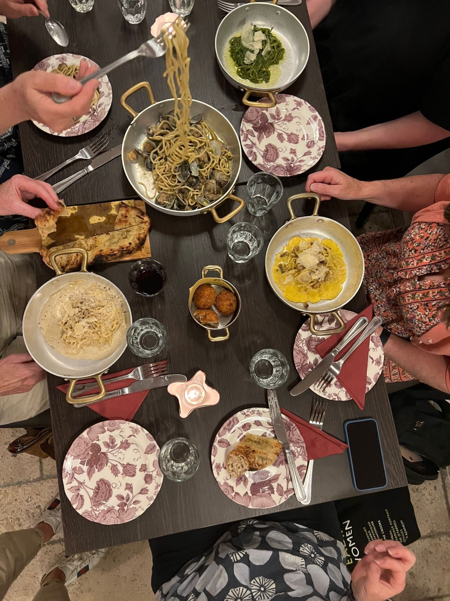 Guests sharing freshly prepared pasta at Pentole & Padelle
